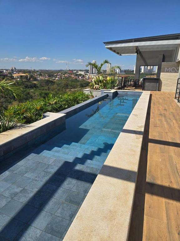a swimming pool on the side of a house at Cozy Moov Smart Apartamento in Cuiabá