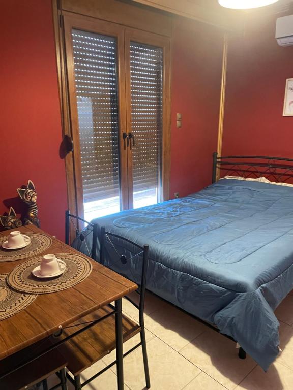 a bedroom with a bed and a wooden table at Serres central house in Serres