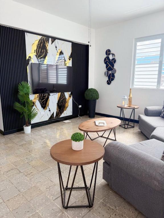 a living room with a couch and a tv at Charming 3BR Near Ponce Attractions in Ponce