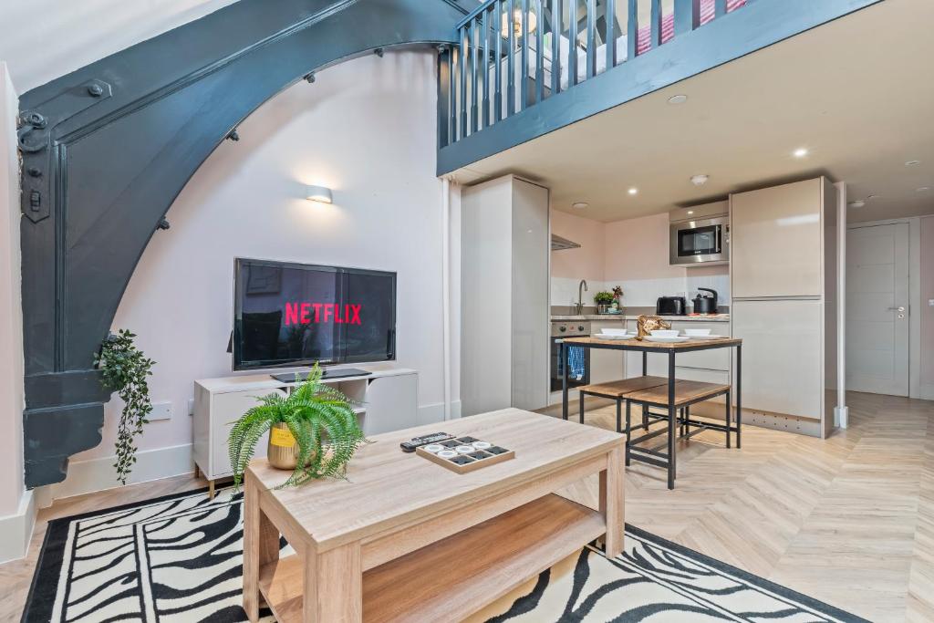 a living room with a table and a staircase at Urban Luxe Loft Hideaway in Central Station