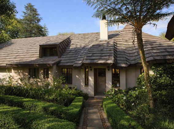 a house with a shingled roof and a tree at Hilton Creek in Hilton