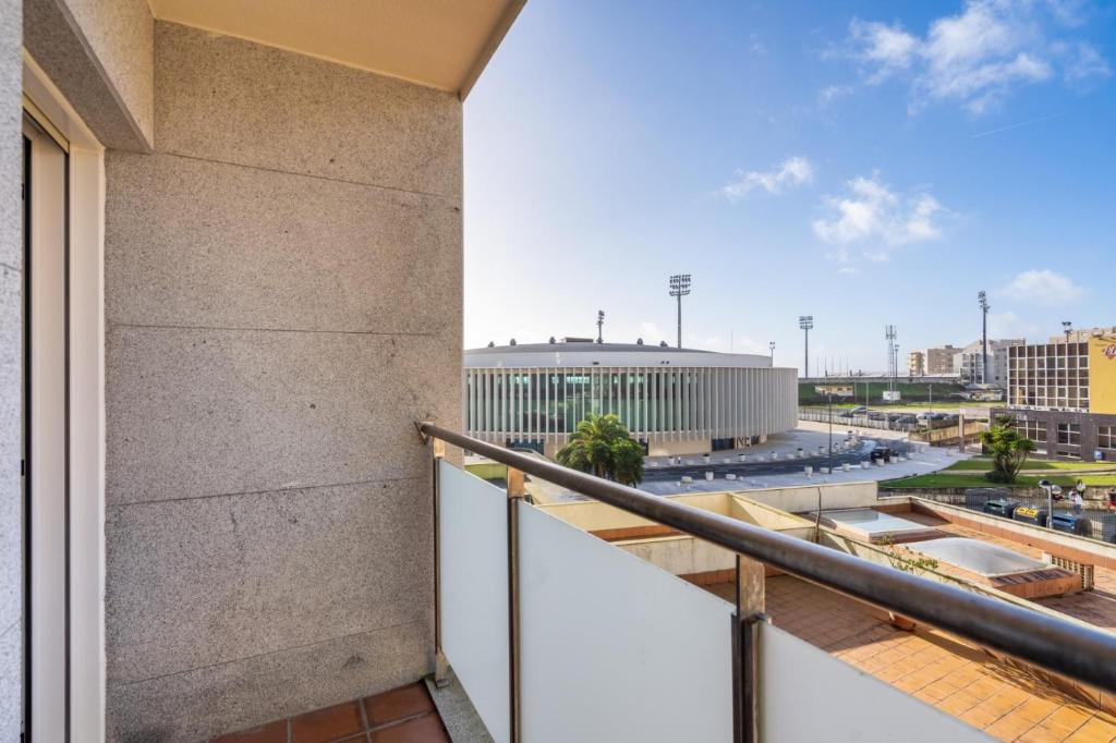 a balcony with a view of a building at Sunny Beachside Escape by Minho's Guest in Póvoa de Varzim