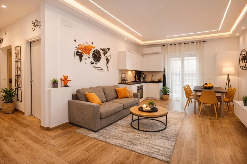 a living room with a couch and a table at Le Rotte di Antonella in Lido di Ostia