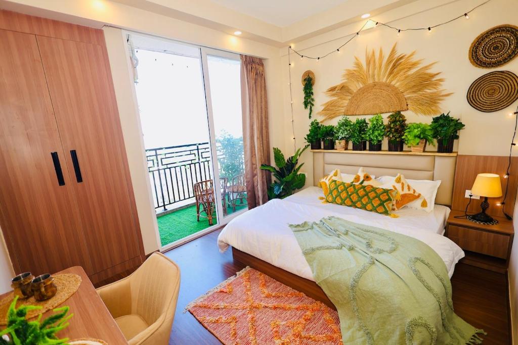 a bedroom with a bed and a large window at Sunleaf Studio Pari Chawk Expo Mart in Greater Noida