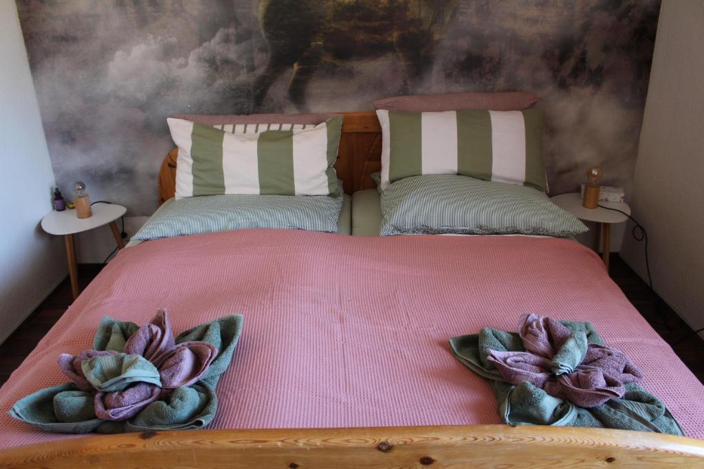 a bedroom with a bed with two flowers on it at Appartement Erzgebirge in Schönheide
