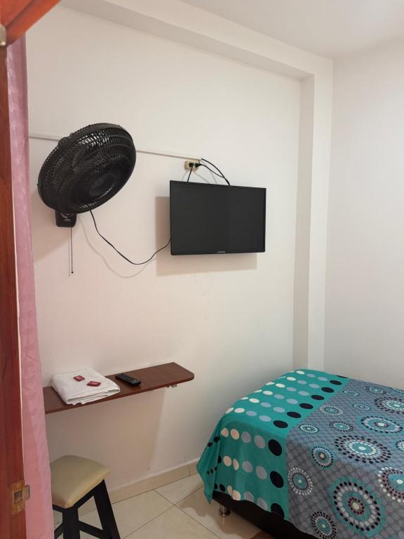 a bedroom with a bed and a television on the wall at Hotel don Nilo in Albania