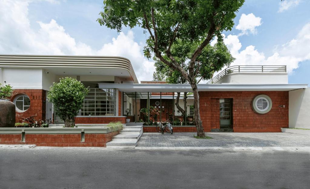 a red brick house with a tree in front of it at Villa Ceria Dukuh in Timuran