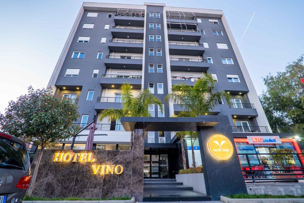 a building with a hotel vino sign in front of it at Hotel Vino in Durrës