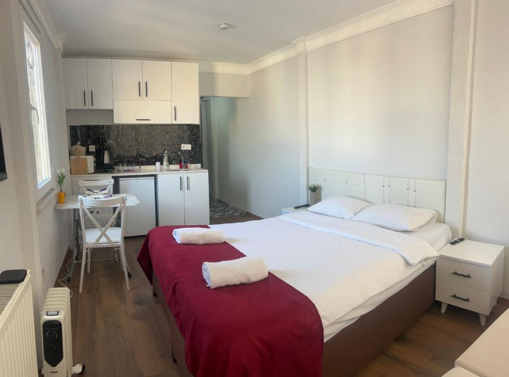 a bedroom with a large bed with a red blanket at Balat Life Suites in Istanbul