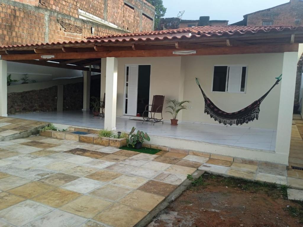 a house with a hammock on the side of it at Casa do Descanso in Triunfo