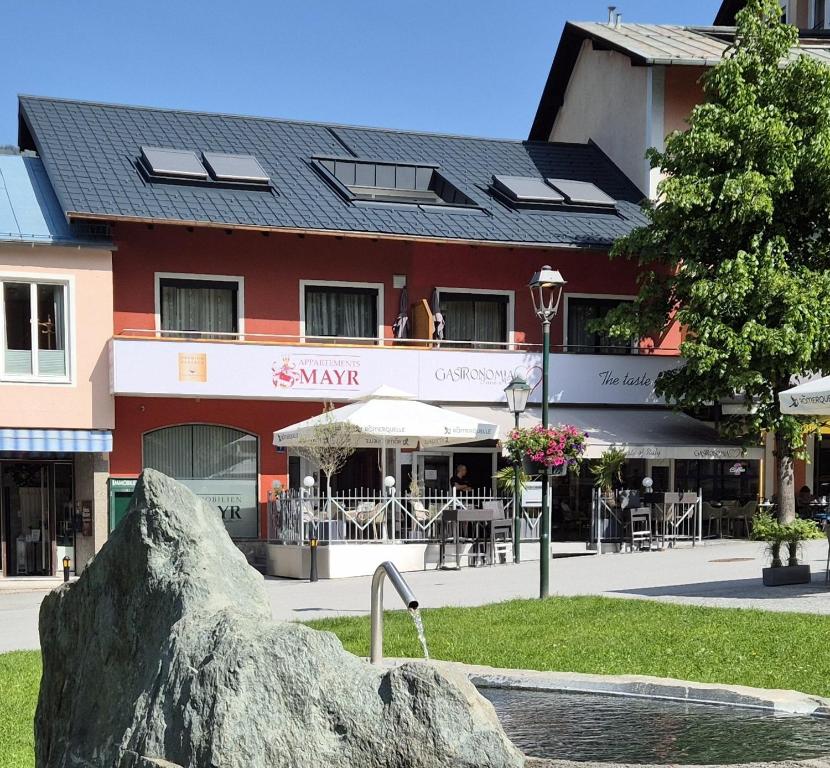 a large rock in front of a building at Appartements MAYR inklusive ganzjährig GRATIS Zugang zur ALPENTHERME und im SOMMER kostenlose Bergbahnnutzung in Bad Hofgastein
