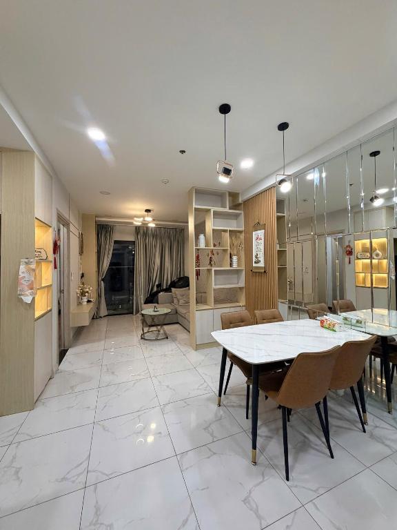 a large living room with a table and chairs at Youyi House in Dĩ An