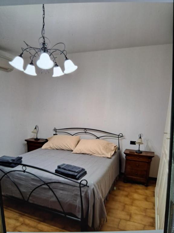 a bedroom with a bed and a chandelier at appartamento yuliet in Città di Castello