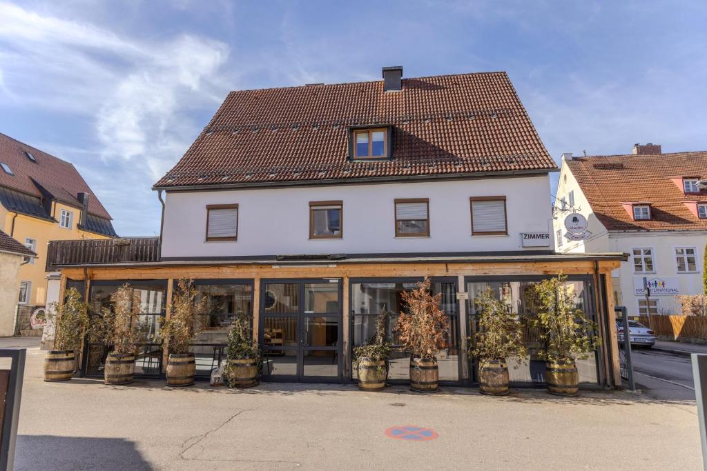 a building with glass doors and potted plants at Chaplin in Kempten