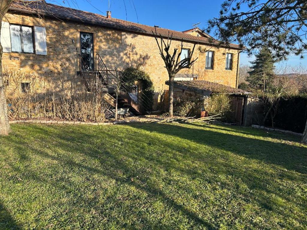 a house with a grass yard in front of it at Les Granges Dorées in Châtillon