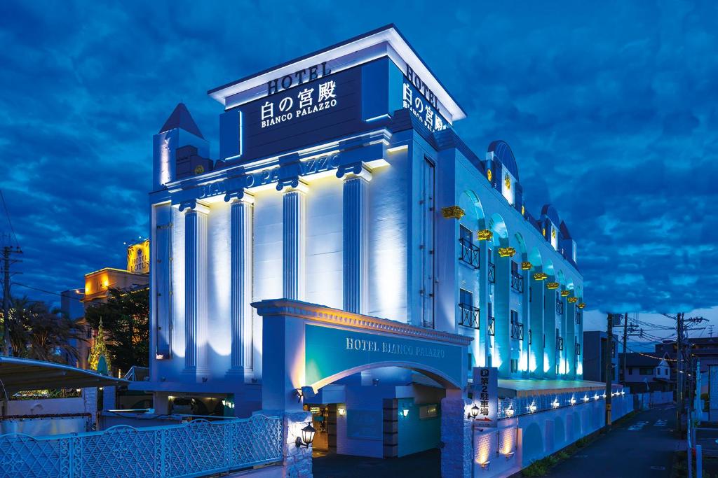 a large building with lights on it at night at Hotel Shiro No Kyuden in Ibaraki