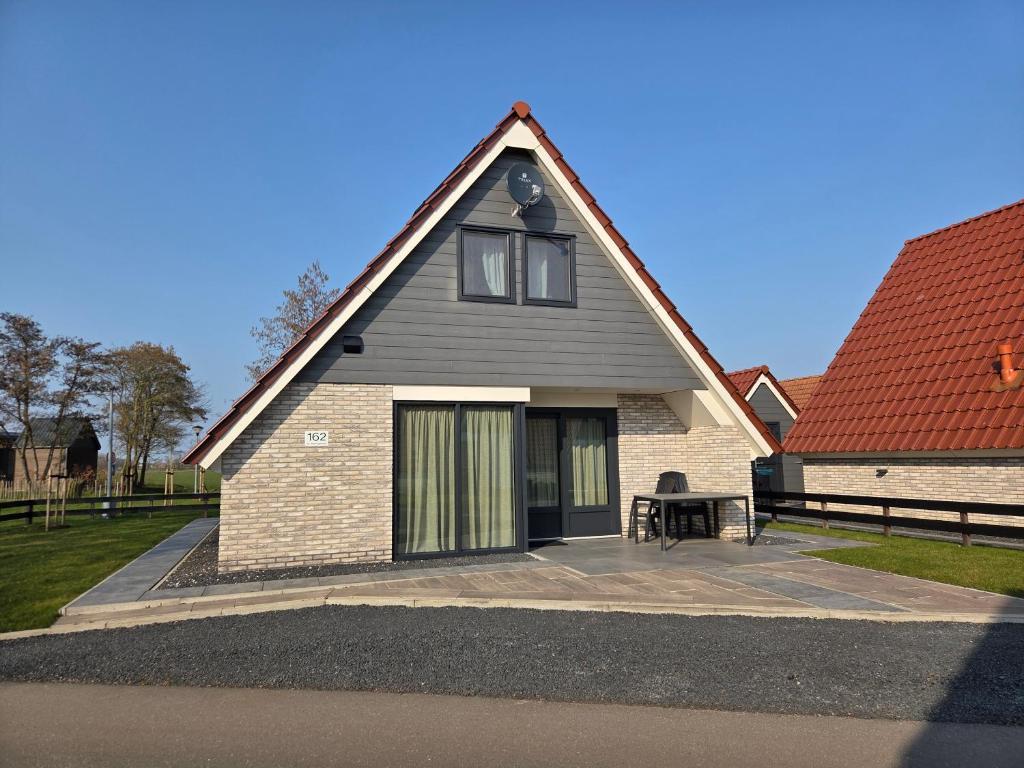 a house with a table in front of it at De Wieringerheid 162 in Den Oever