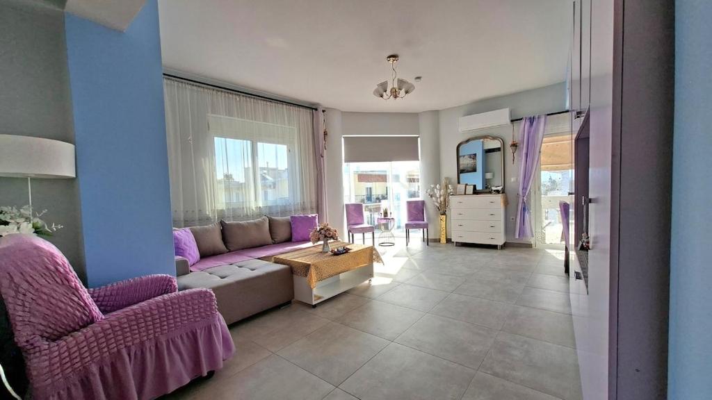 a living room with purple furniture and purple chairs at Mary's Apartment - Close to port, beaches in Kos
