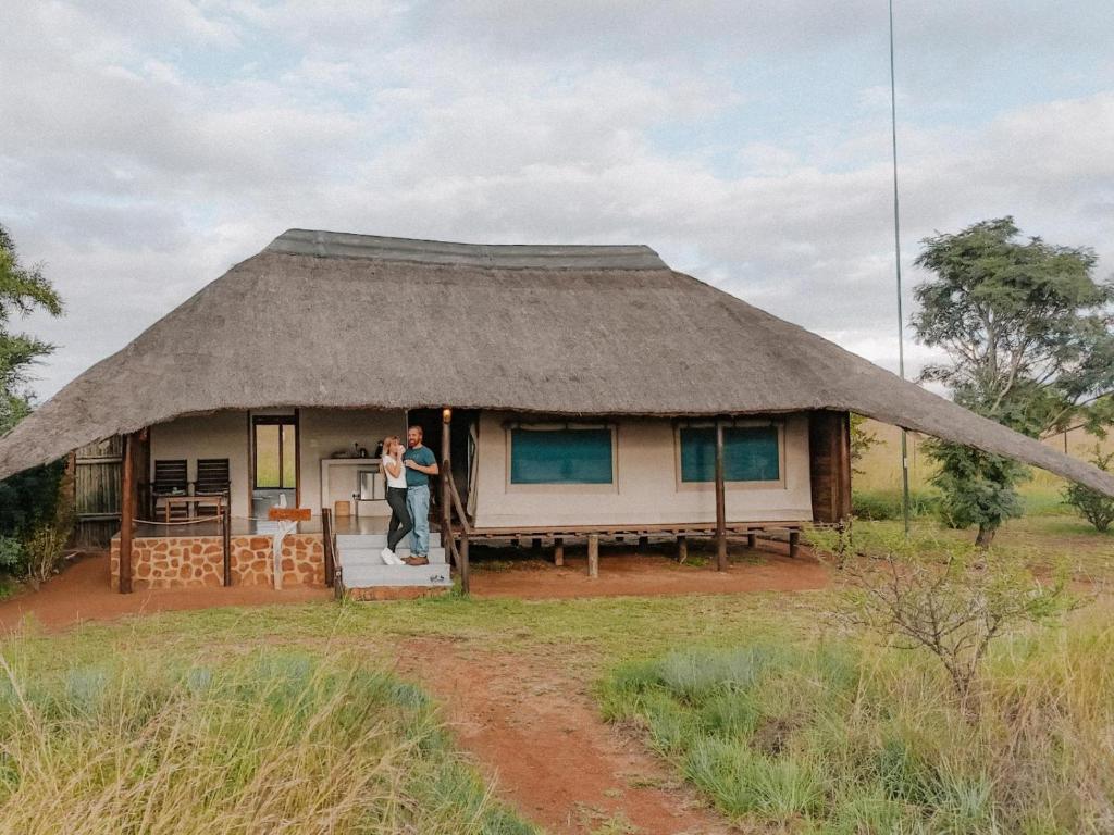 a man standing in the doorway of a hut at Butjani Lodge in Cullinan