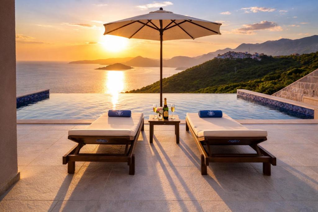 a infinity pool with two beds and an umbrella at Villa Miramare in Blizikuće