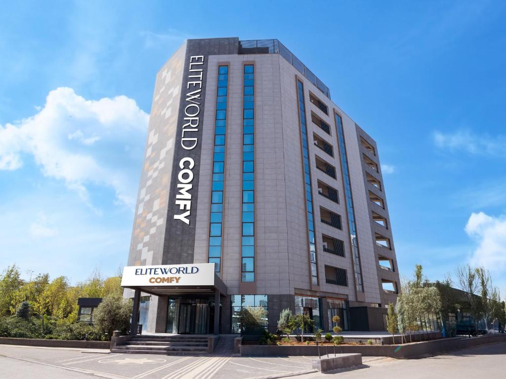 a tall building with a sign in front of it at Elite World Comfy Diyarbakır in Diyarbakır