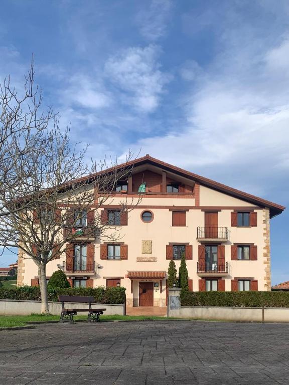 a building with a bench in front of it at Amari in Getaria