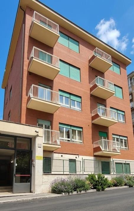 a brick building with balconies on the side of it at Casa Per Ferie Canobi 18 in Rome