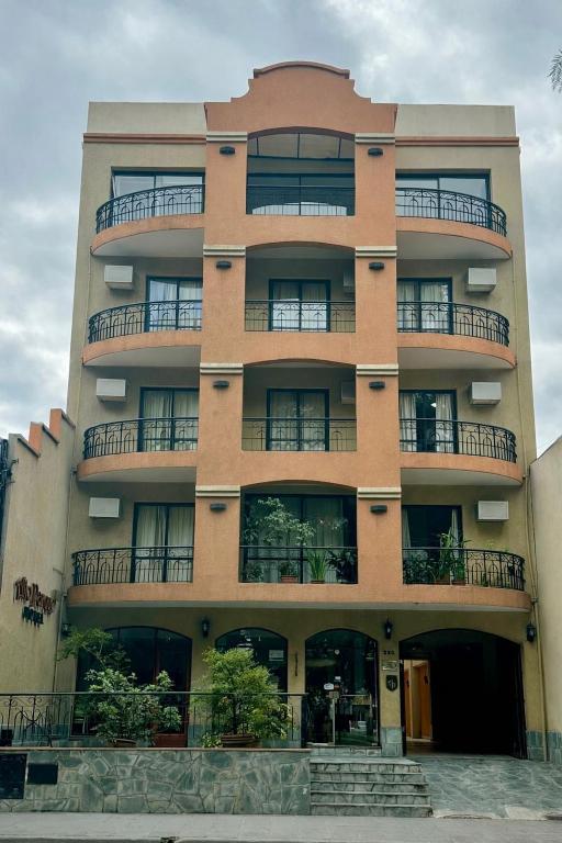 a tall building with balconies on the side of it at Altoparque Hotel Salta in Salta