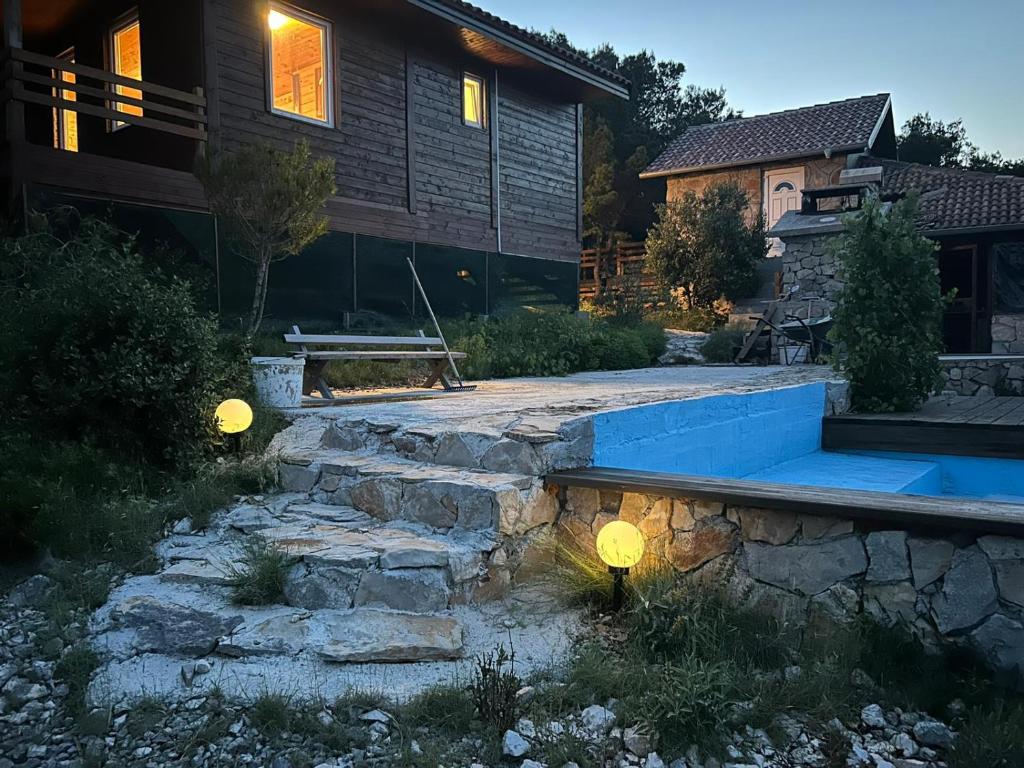 a backyard with a swimming pool and a house at Marepromo Žirje in Žirje