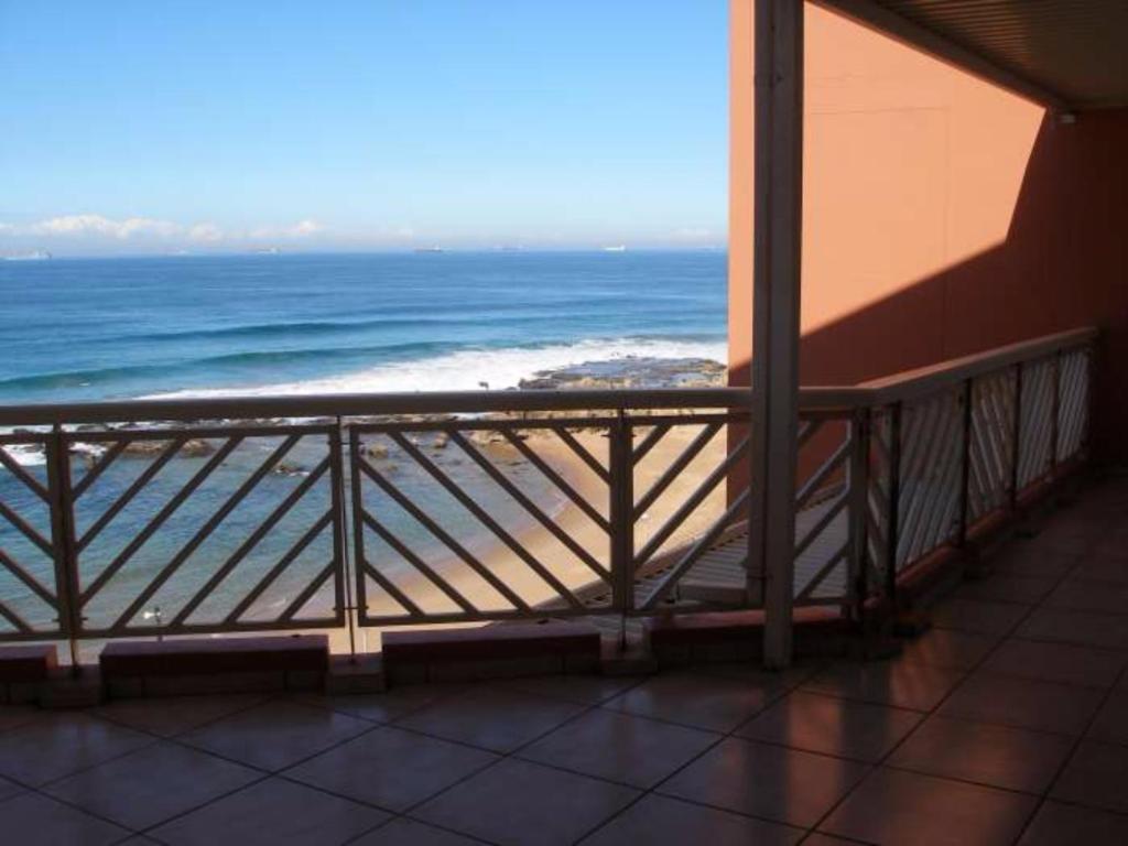 a balcony with a view of the ocean at Sorgente 405 with inverter in Umdloti