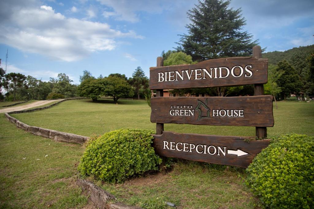 a sign for the green house and reception at the park at Green House in Villa General Belgrano