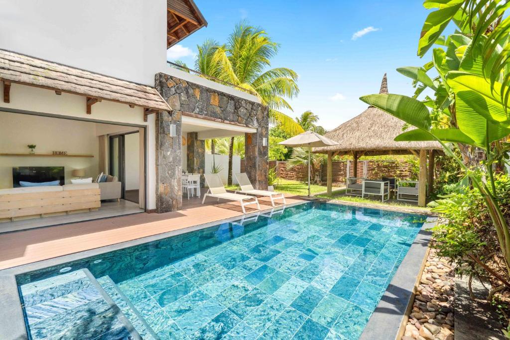 an image of a villa with a swimming pool at Ama Villas - Luxury Private Villas in Mont-Choisy Beach in Mont Choisy