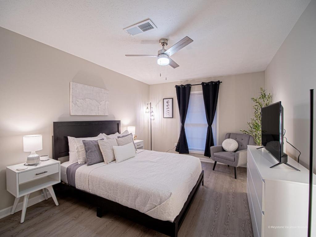 a bedroom with a bed and a flat screen tv at The Battery Hideaway in Marietta