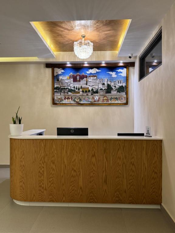 a reception desk with a picture on the wall at Tashi Tagay Hotel & Apartment in Kathmandu