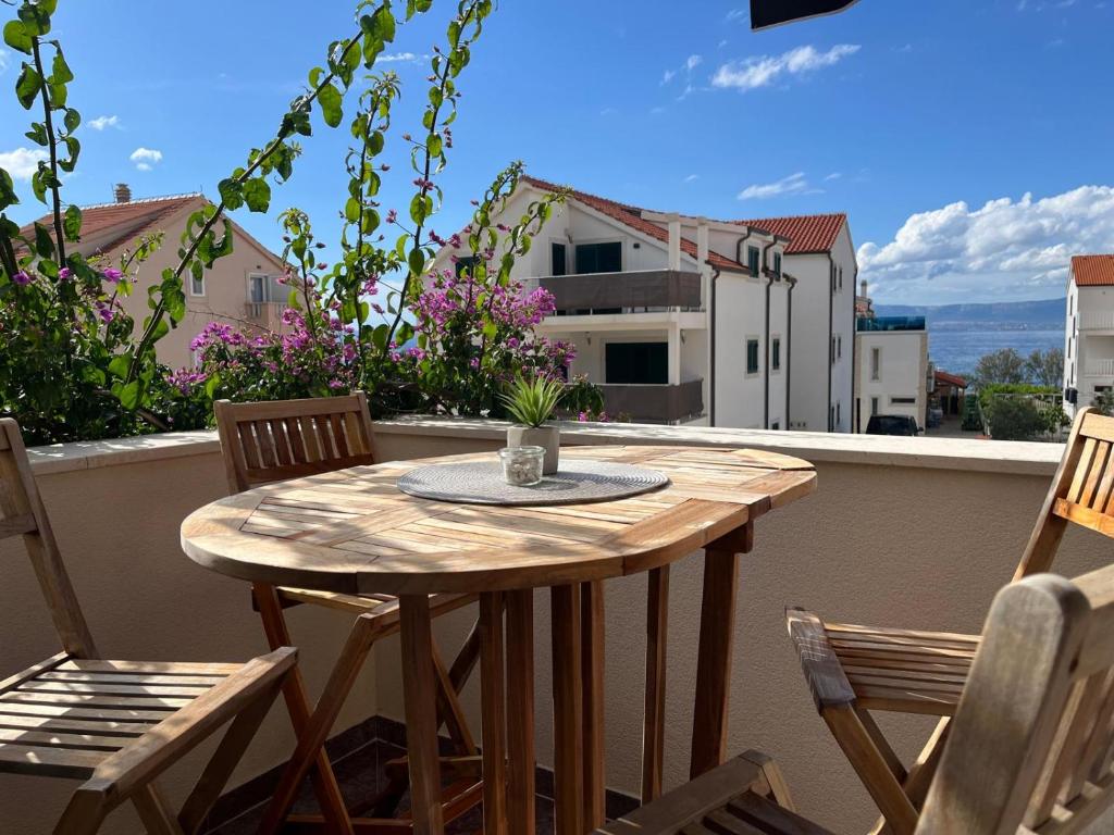 a wooden table and chairs on a balcony at BCM Weidinger in Mirce