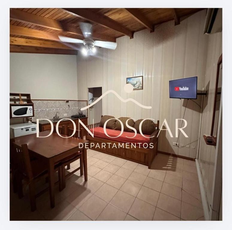 a dining room with a table and a sign on the wall at apartamentos Don Oscar in Federación