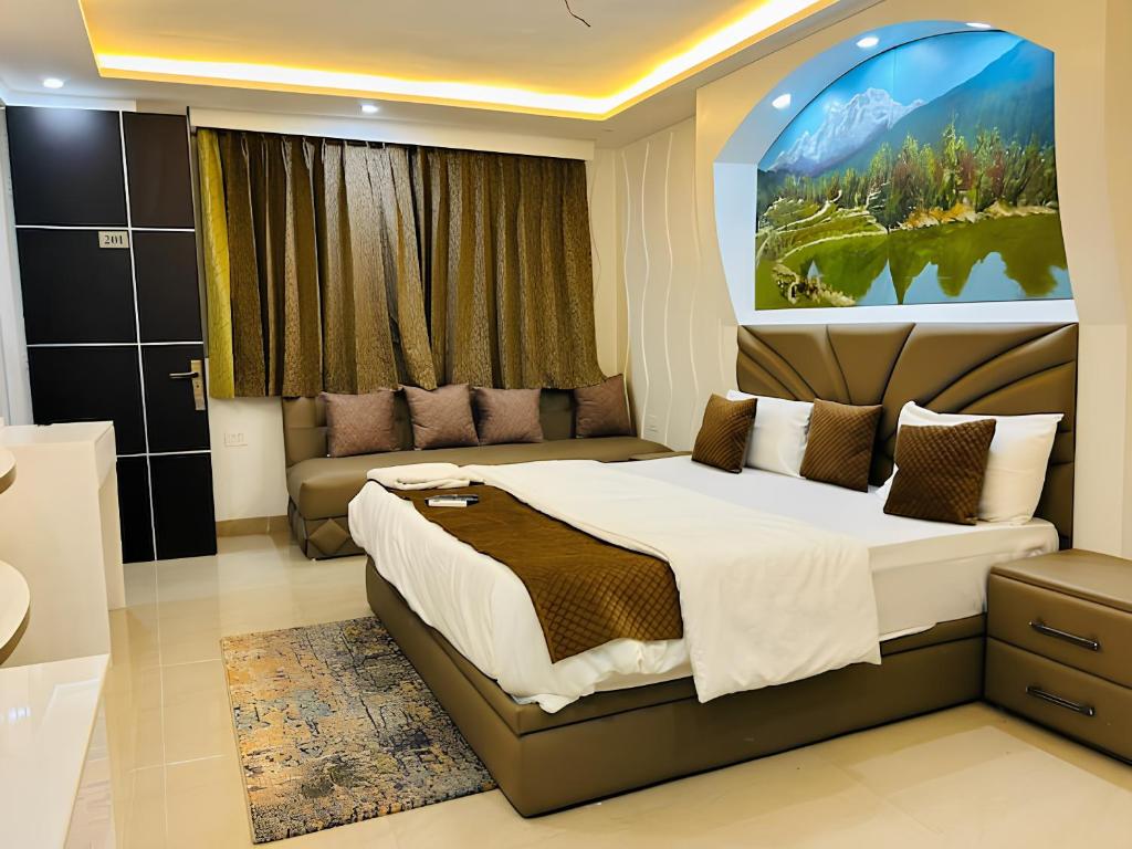 a bedroom with a large bed and a couch at The Starfish Studio in Dehradun