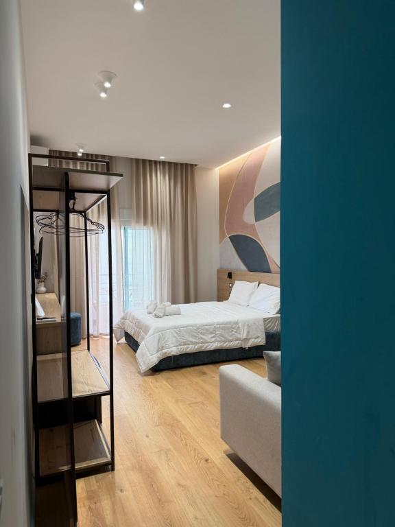 a bedroom with a bed and a couch in it at Xhani Boutique Rooms in Durrës