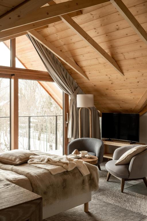 a bedroom with a bed and a large window at Nova Hill in Zakopane