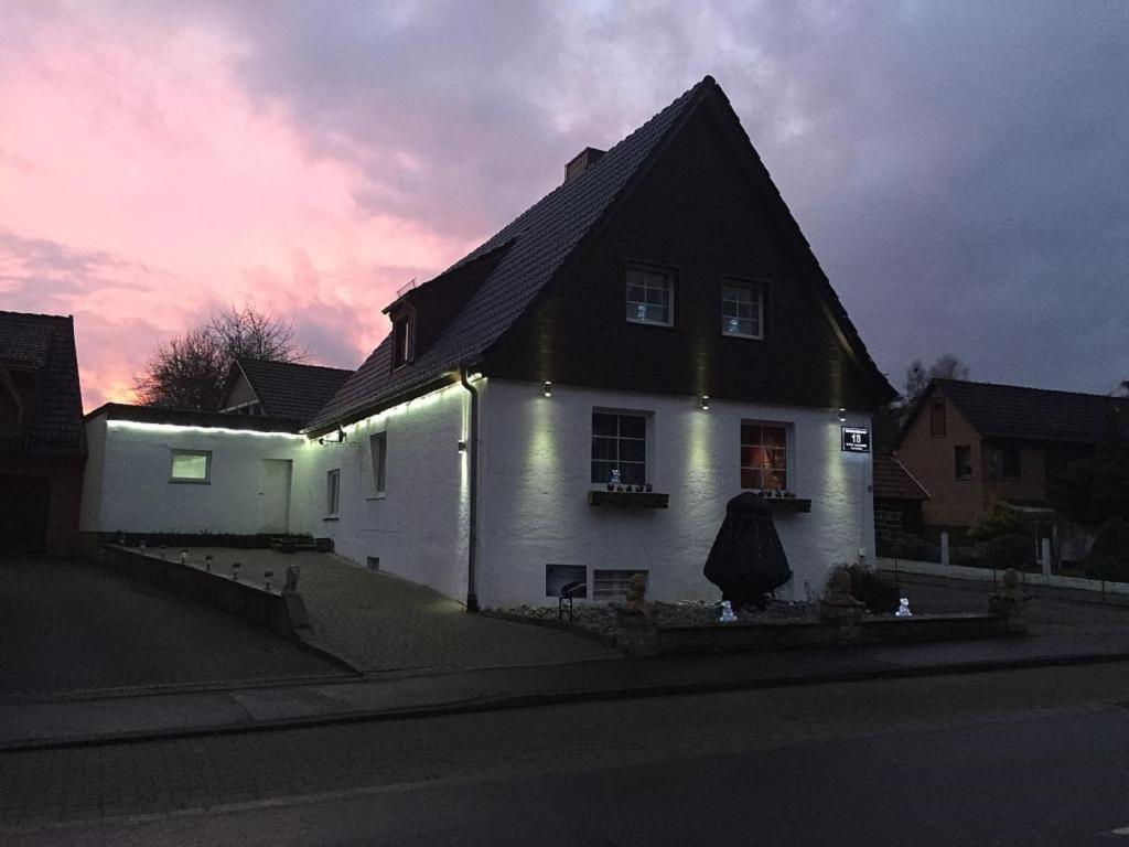a white house with lights on the side of it at Ferienhaus Harz in Bad Sachsa