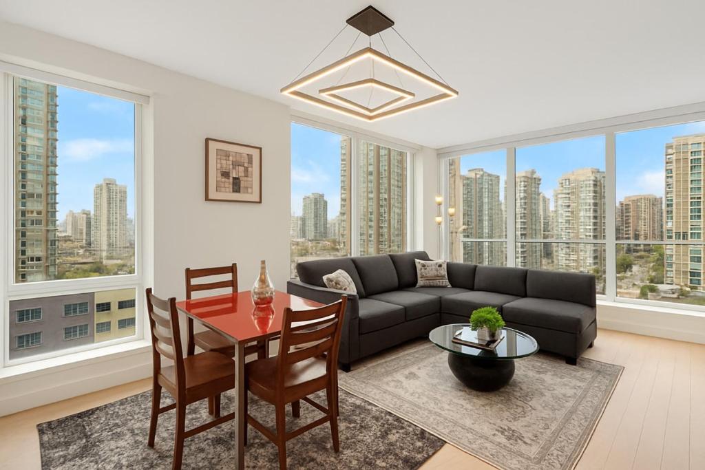 a living room with a couch and a table at Modern Corner apartment in downtown in Vancouver