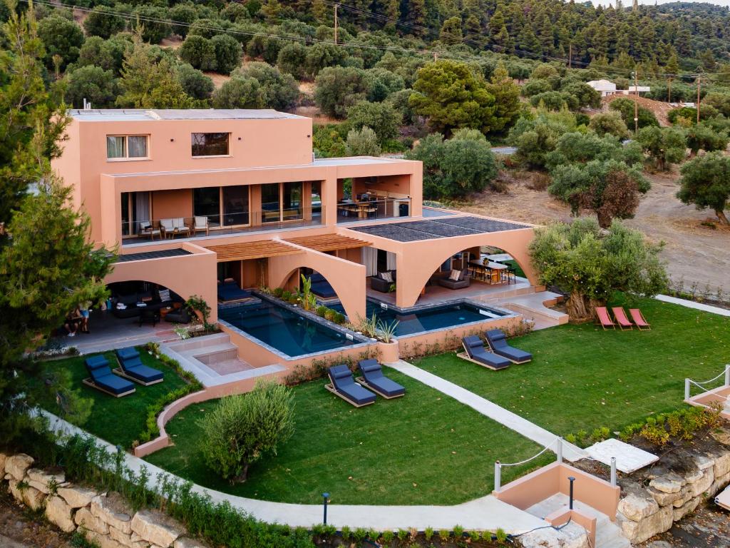 an aerial view of a villa with a swimming pool at Euphoria Villa, 9 bdrs with private pools, beachfront in Kalogria
