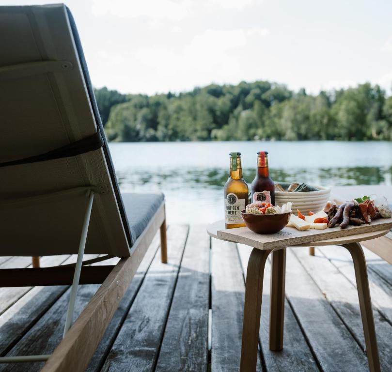 a table with a bowl of food and two bottles of beer at Hotel Stiegl-Gut Wildshut in Wildshut