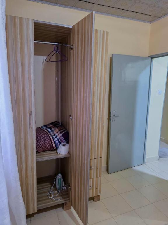 a closet with a bed in it next to a door at Executive 1bedroom Embu by Tsparks in Embu