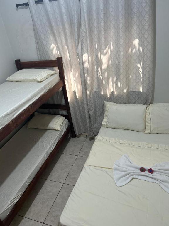 a room with two bunk beds with a shirt on them at Pesqueiro Rancho dos Reis in Aquidavana