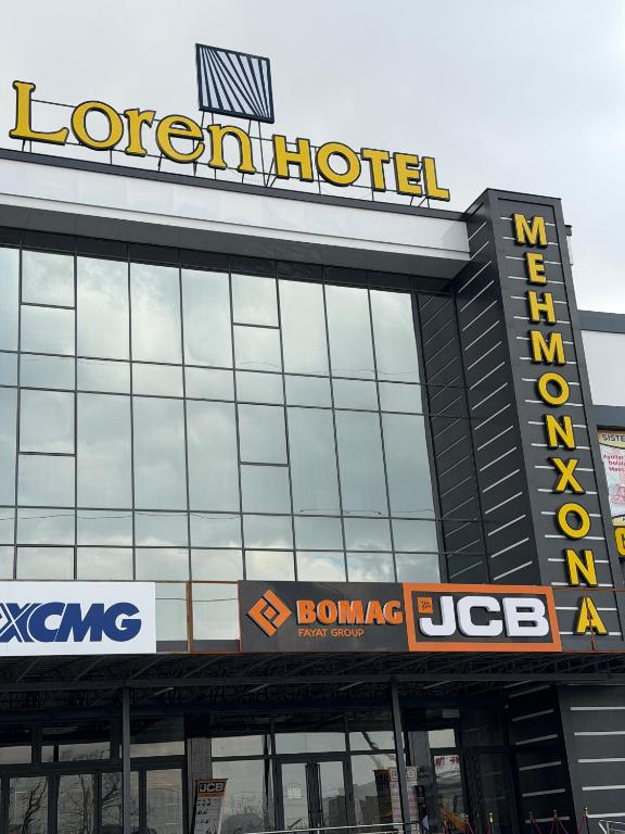 a hotel with a sign on top of a building at Loren Hotel in Tashkent