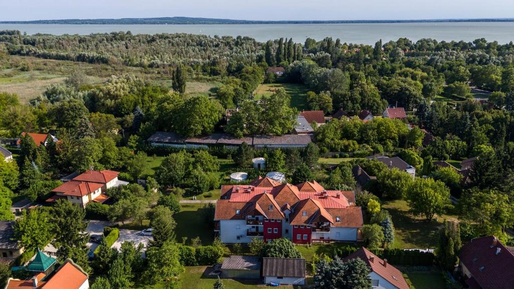 an aerial view of a house with trees and water at Mézi Lazy in Gyenesdiás