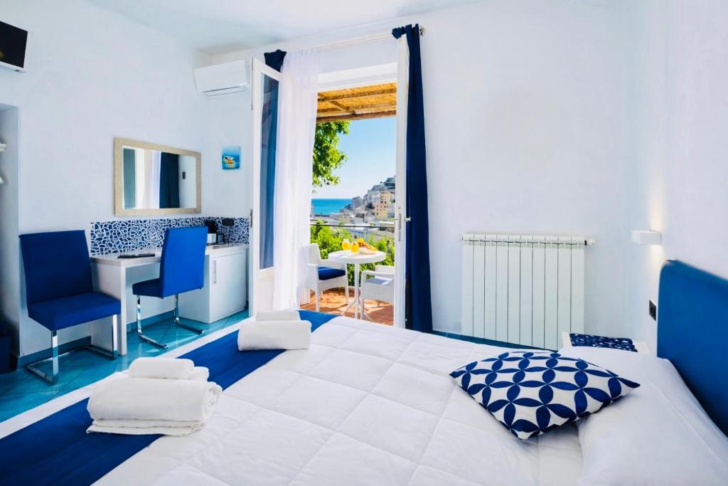 a bedroom with a bed and a view of the ocean at Eden Holiday in Minori