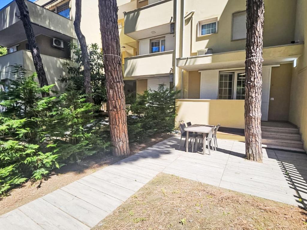 a table and chairs on a sidewalk in front of a building at Holiday Home Veranda-2 by Interhome in Rosapineta
