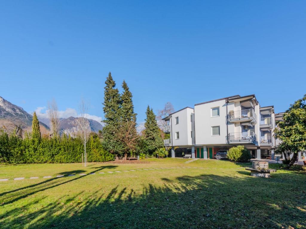 a large grassy yard in front of a building at Apartment Ilaria by Interhome in Riva del Garda